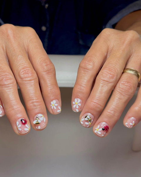 short ladybug nails with daisies and bees on negative space